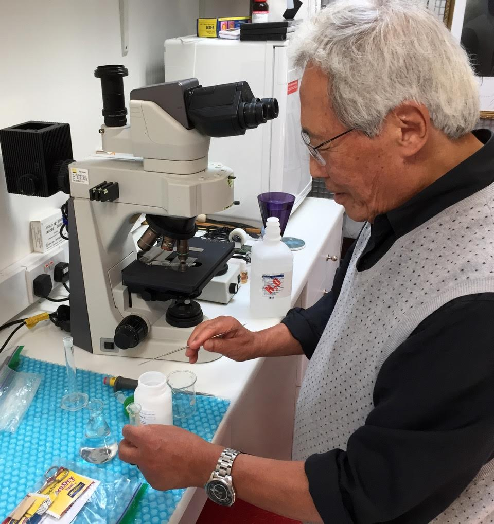 Dr Sungchul Ji preparing yeast samples at the microscope